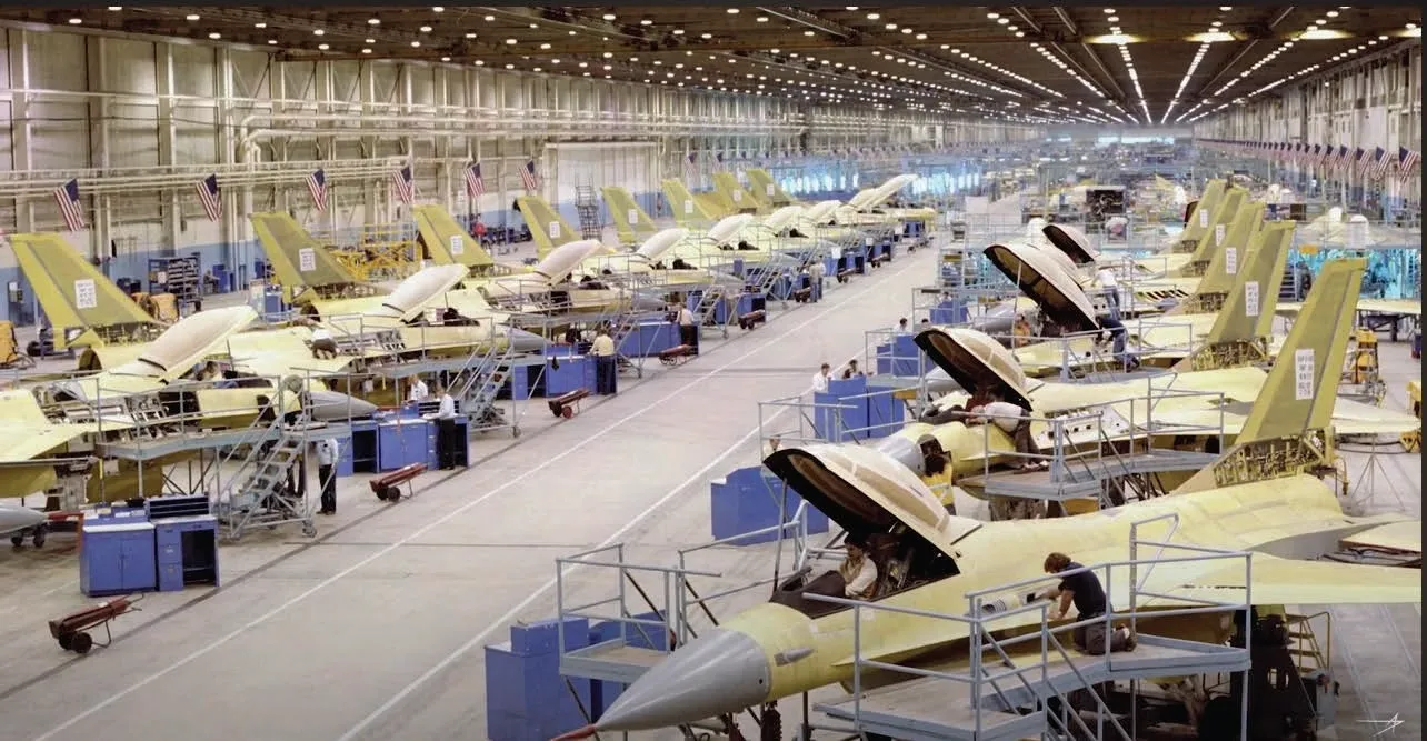 A large hangar filled with lots of jets.