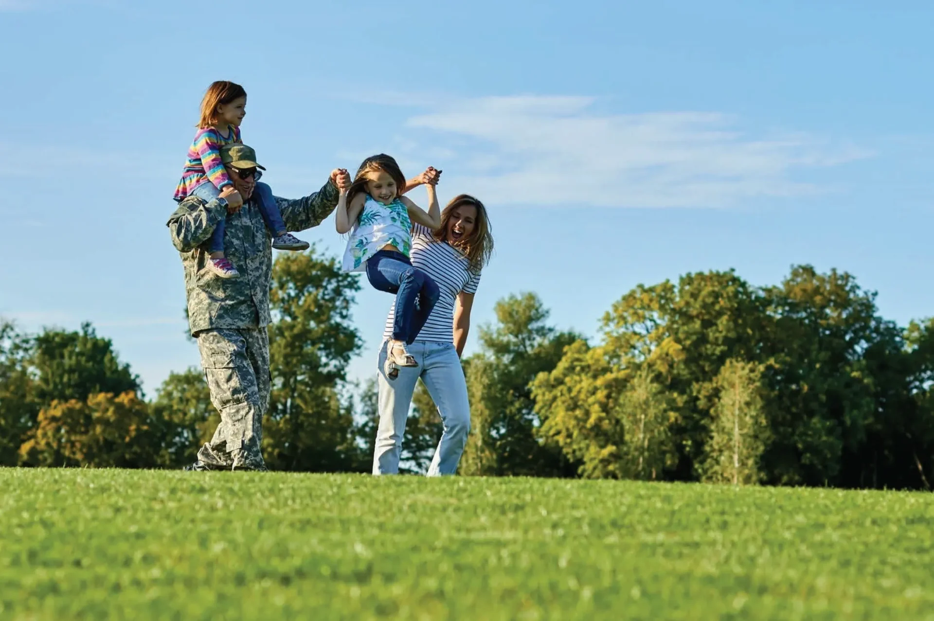 A woman and two women are playing in the grass.