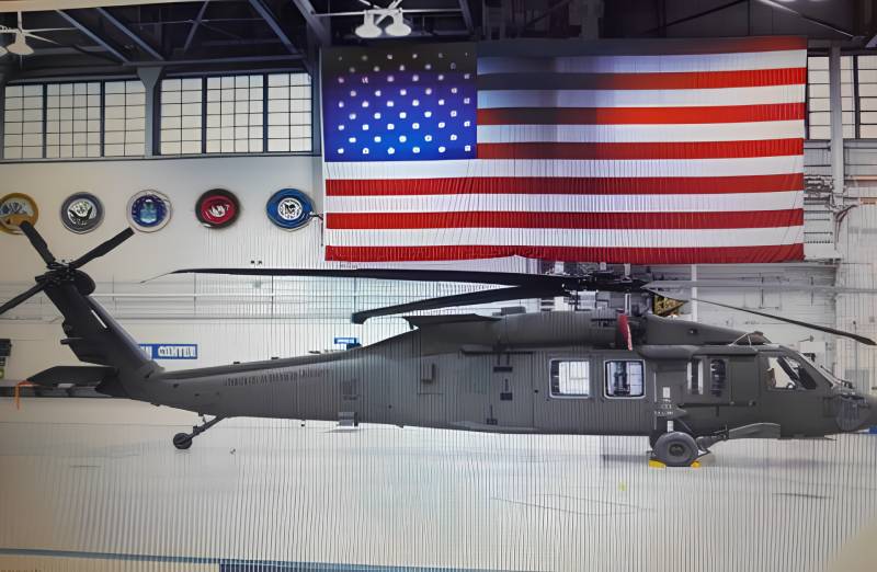 A helicopter hanging from the ceiling of an airplane hangar.